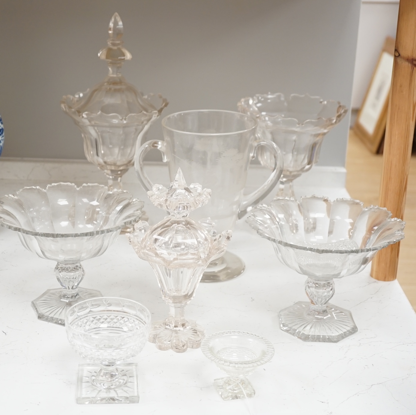 19th century and later glassware to include a pair of glass confitures (one cover), a twin handled etched cup, etc. largest 38cm high. Condition - fair